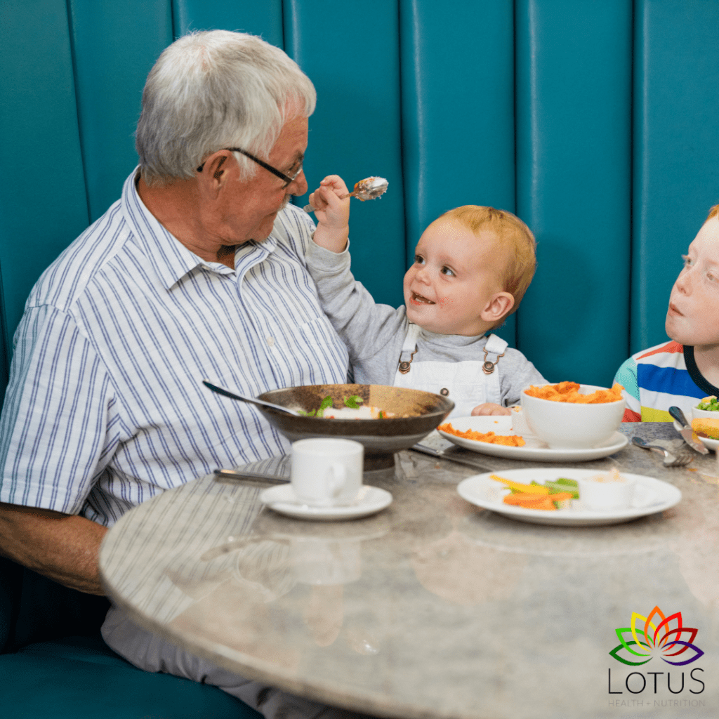 old man and young child at table