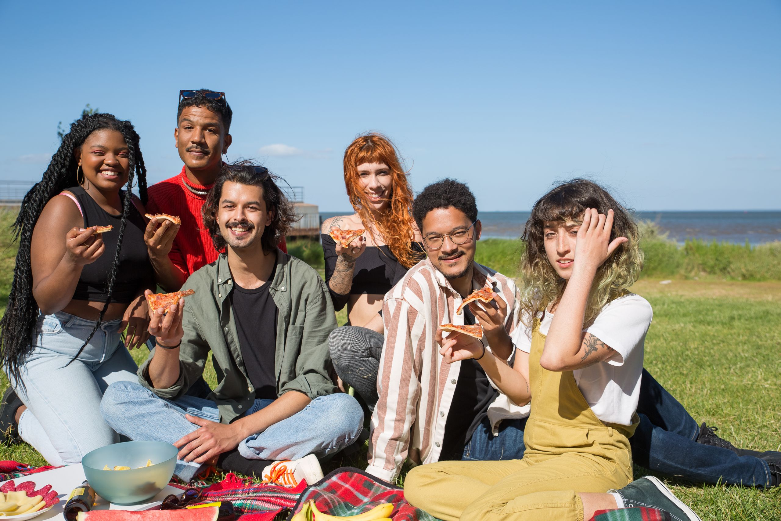 Diverse adults sharing a relaxed meal together, representing a weight-inclusive and non-diet approach to health