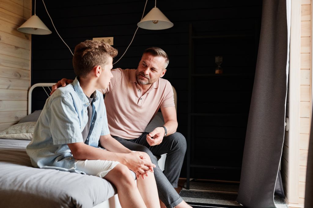 Father and teenage son having a supportive conversation about body image and mental wellbeing
